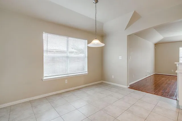 a kitchen with white cabinets and appliances
