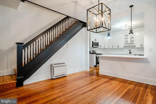 a view of hallway with wooden floor and staircase