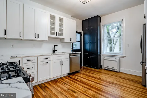 a kitchen with stainless steel appliances a stove a sink and a refrigerator