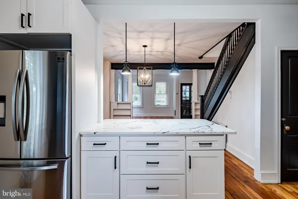 a view of a kitchen with a refrigerator and microwave