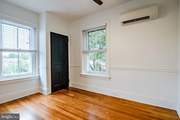 a view of empty room with wooden floor