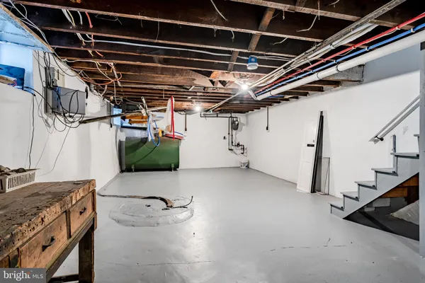 a view of storage and utility room with a refrigerator