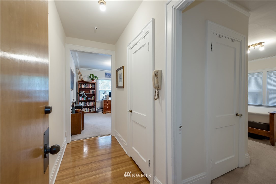 6402 Phinney Avenue North Seattle, WA 98103 - Photo 13 of 17 a view of a hallway with closet and a bathroom