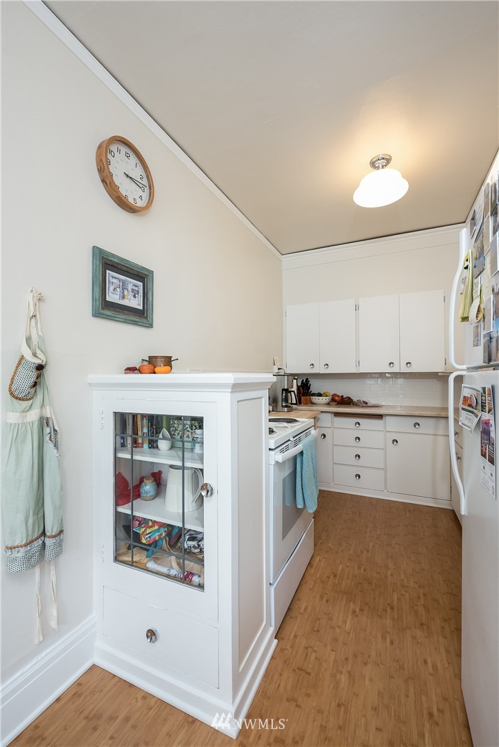 6402 Phinney Avenue North Seattle, WA 98103 - Photo 16 of 17 a kitchen with cabinets and a refrigerator