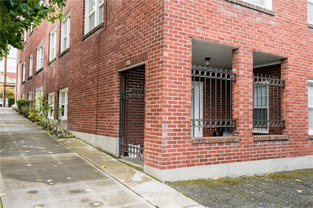 6402 Phinney Avenue North Seattle, WA 98103 - Photo 3 of 17 a view of a brick house with a yard