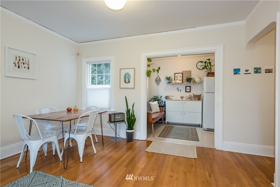 6402 Phinney Avenue North Seattle, WA 98103 - Photo 9 of 17 a view of a dining room with furniture and wooden floor