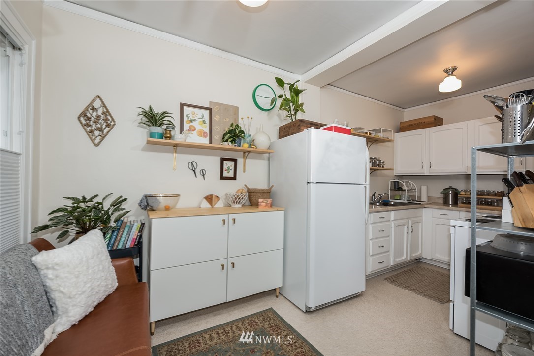 6402 Phinney Avenue North Seattle, WA 98103 - Photo 10 of 17 a white refrigerator freezer sitting inside of a kitchen