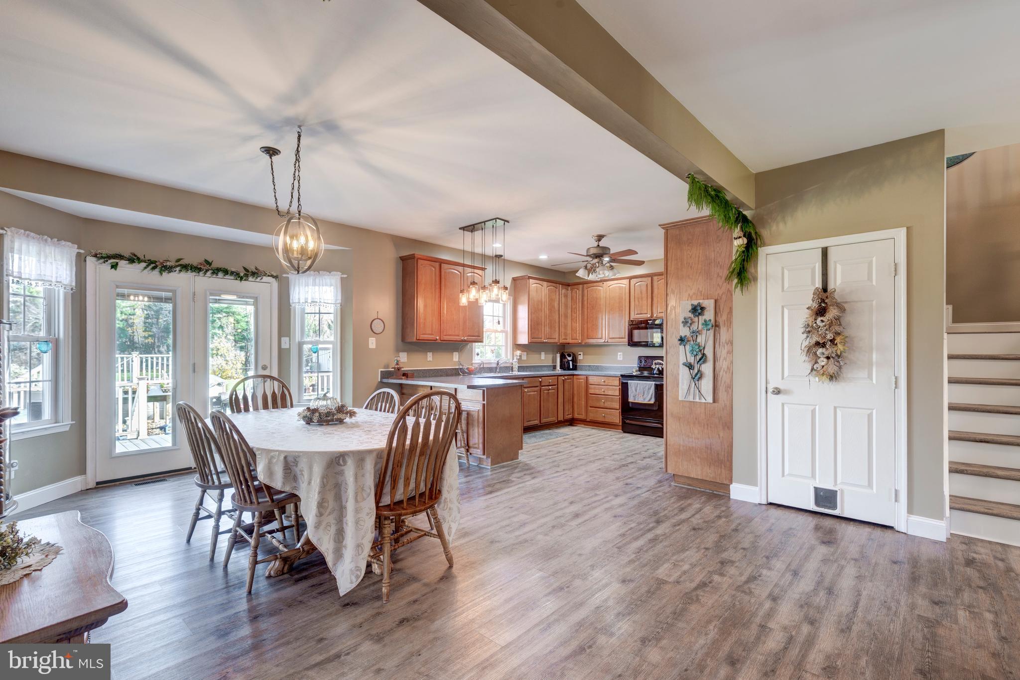 128 Pine Grove Road Hanover, PA 17331 - Photo 11 of 93 a view of a dining room and livingroom with furniture wooden floor a chandelier