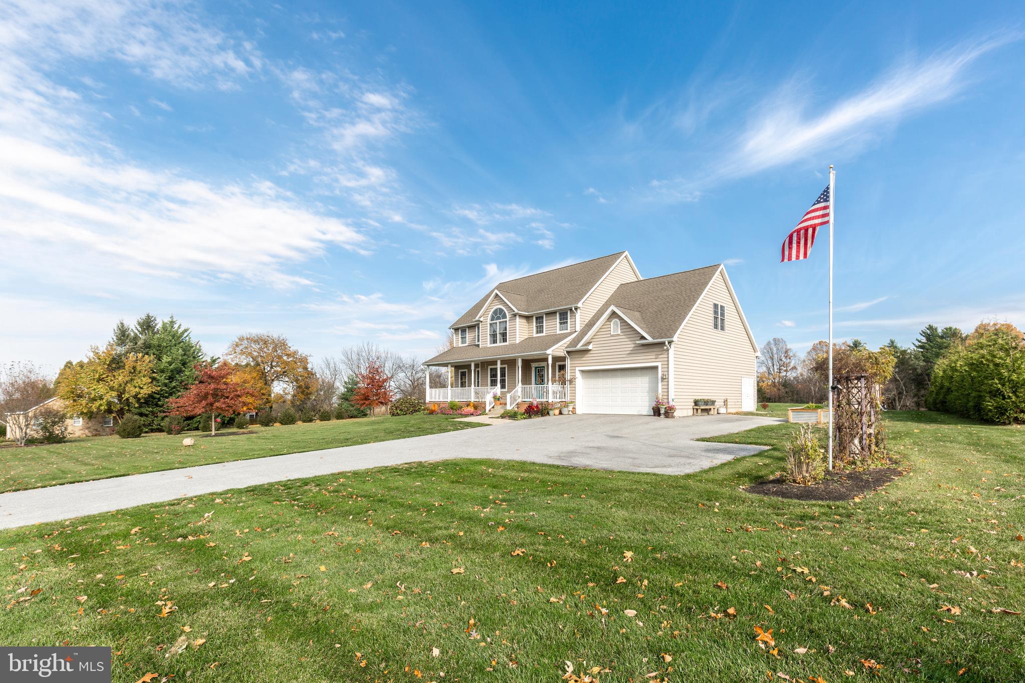 128 Pine Grove Road Hanover, PA 17331 - Photo 2 of 93 a view of a house next to a big yard with plants and large trees