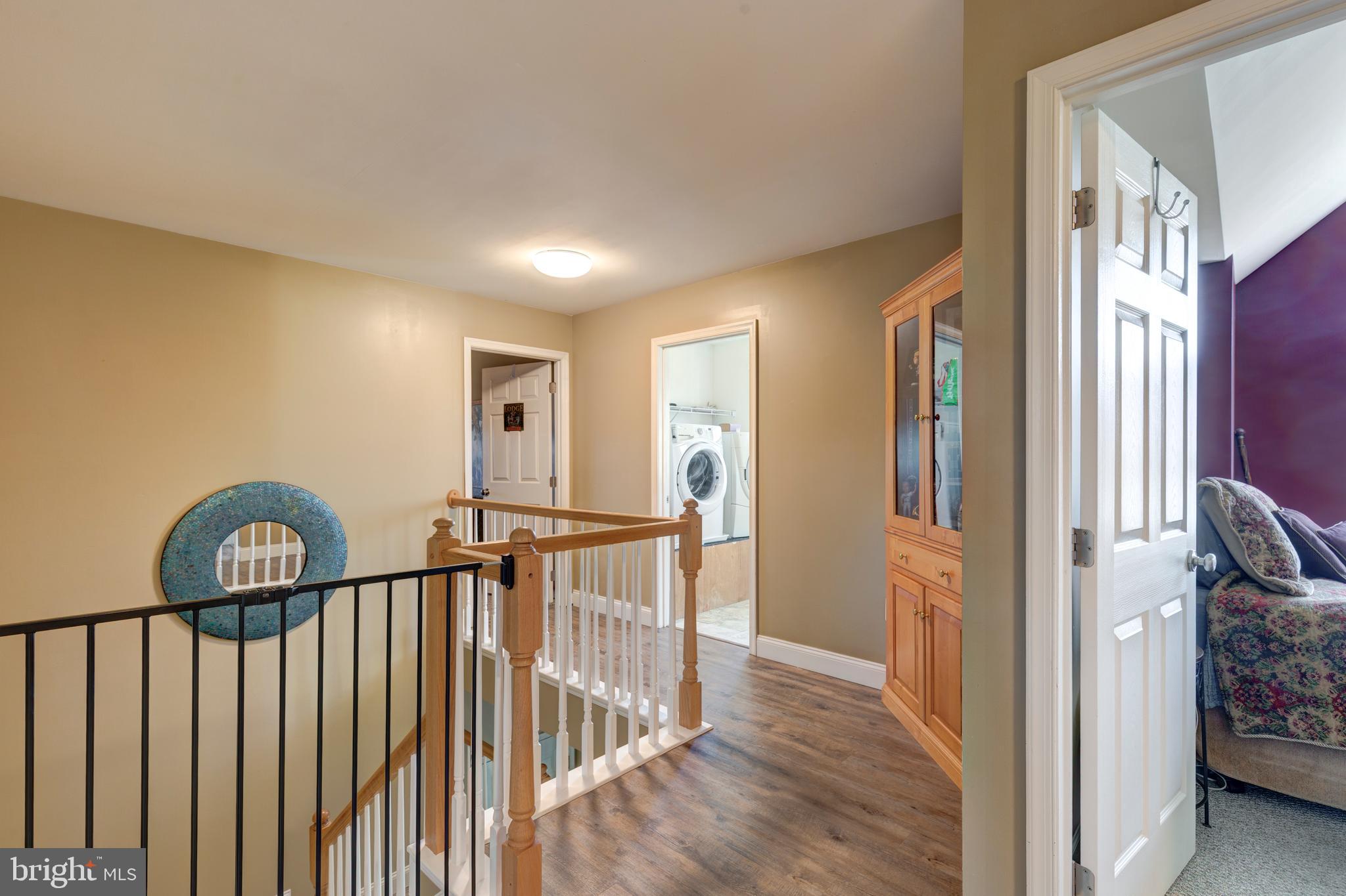 128 Pine Grove Road Hanover, PA 17331 - Photo 26 of 93 a view of hallway with wooden floor and stairs