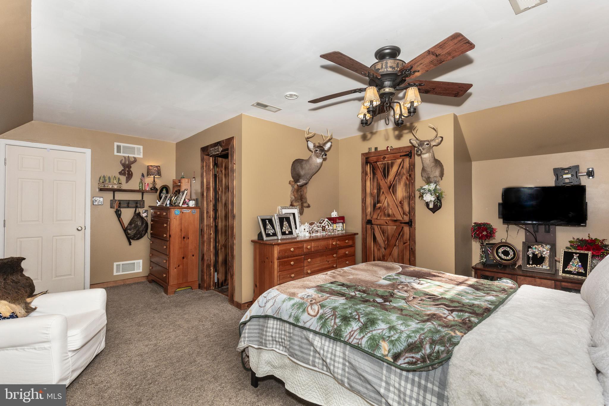 128 Pine Grove Road Hanover, PA 17331 - Photo 41 of 93 a bedroom with a bed and a chandelier