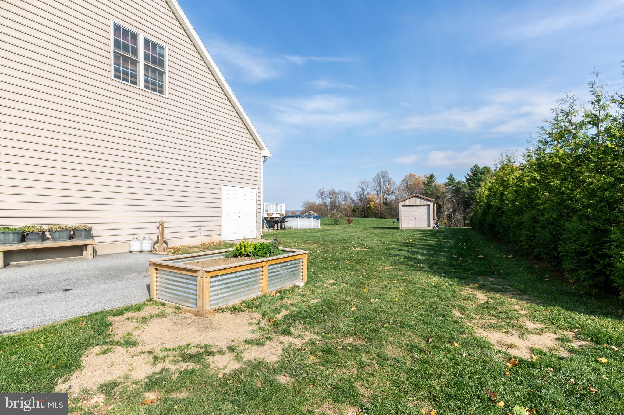 128 Pine Grove Road Hanover, PA 17331 - Photo 92 of 93 a backyard of a house with table and chairs