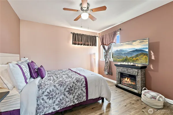 a bedroom with a bed and a fireplace