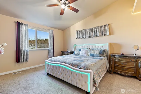 a bedroom with a bed a window and dresser