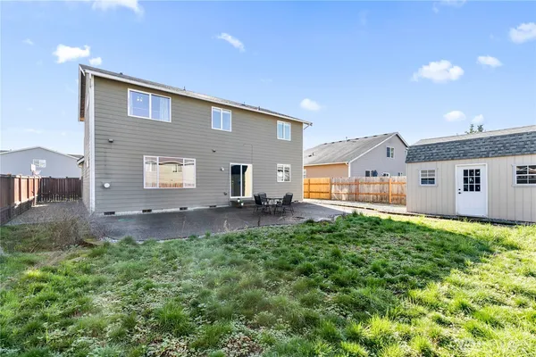 a backyard of a house with yard and outdoor seating
