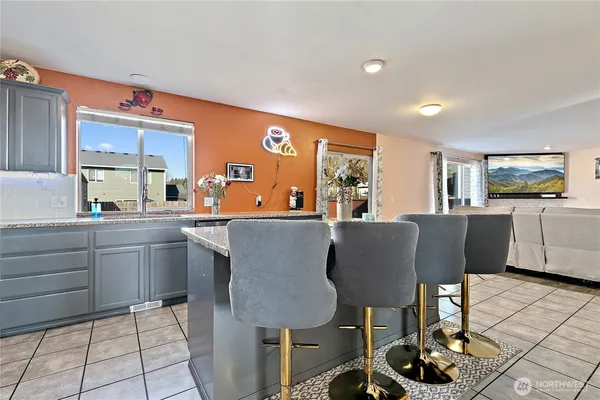a kitchen with stainless steel appliances granite countertop a sink and a refrigerator