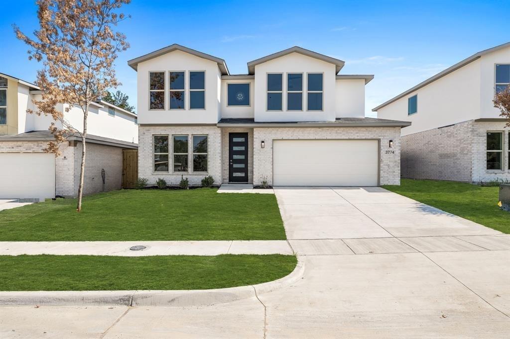a front view of a house with a garden and yard