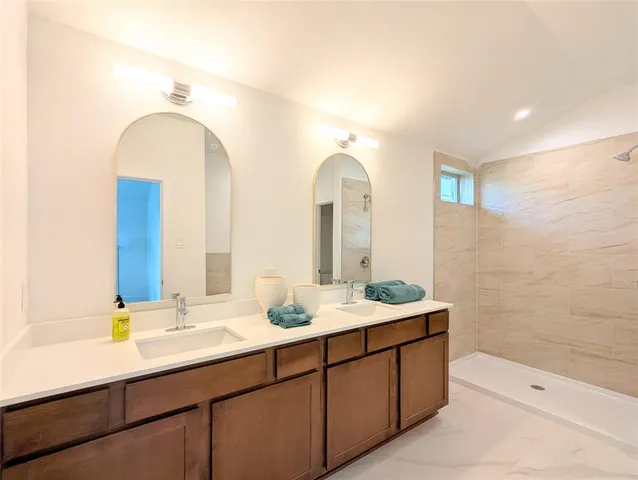 a bathroom with a double vanity sink and a mirror