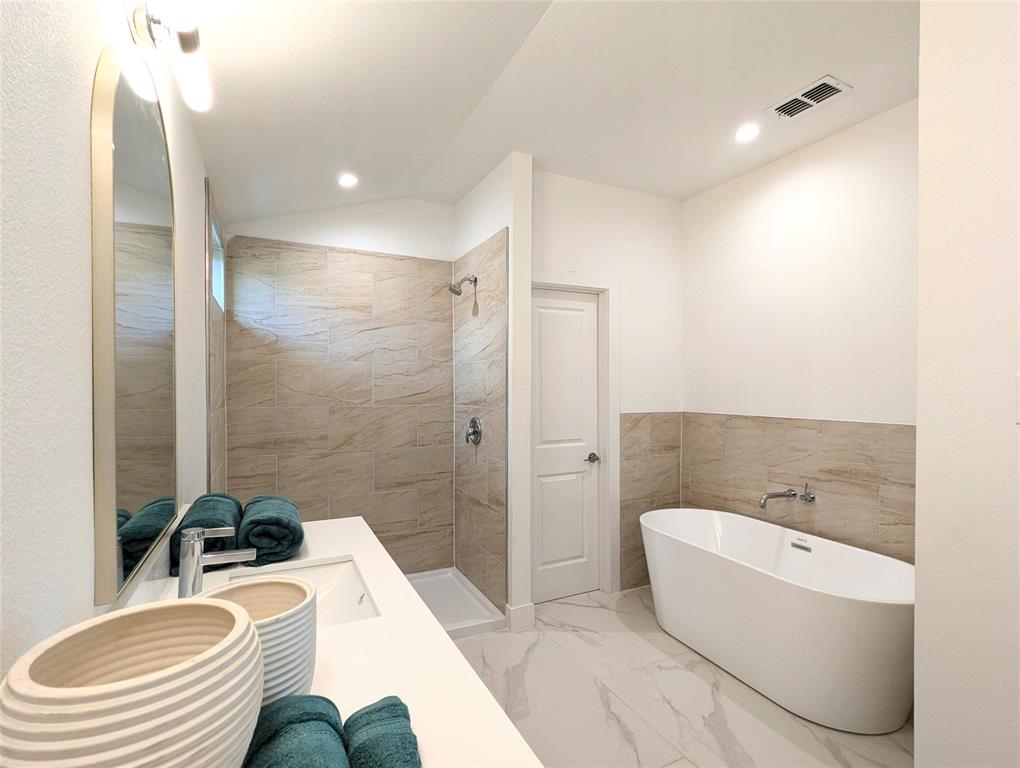 3786 Wenatche Drive Dallas, TX 75233 - Photo 12 of 16 a bathroom with a sink a bathtub and a toilet