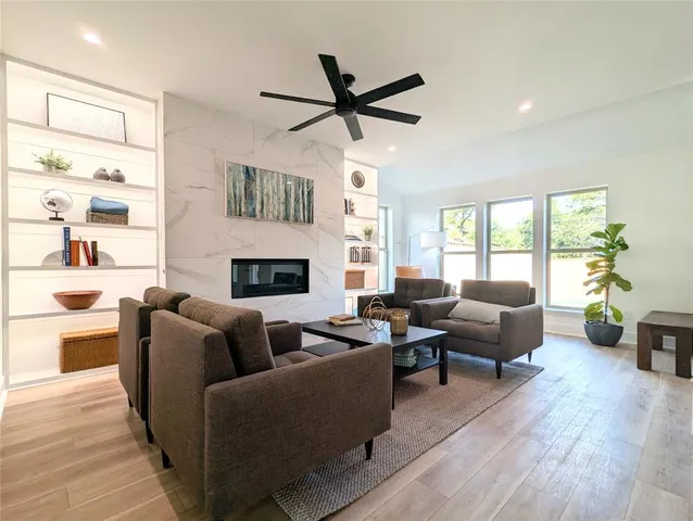 a living room with furniture wooden floor and a fireplace