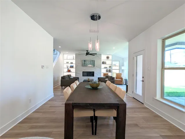 a view of a dining room with furniture a chandelier and wooden floor