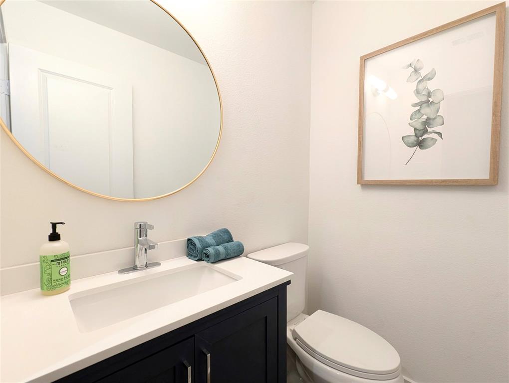 3786 Wenatche Drive Dallas, TX 75233 - Photo 8 of 16 a bathroom with a sink mirror vanity and toilet