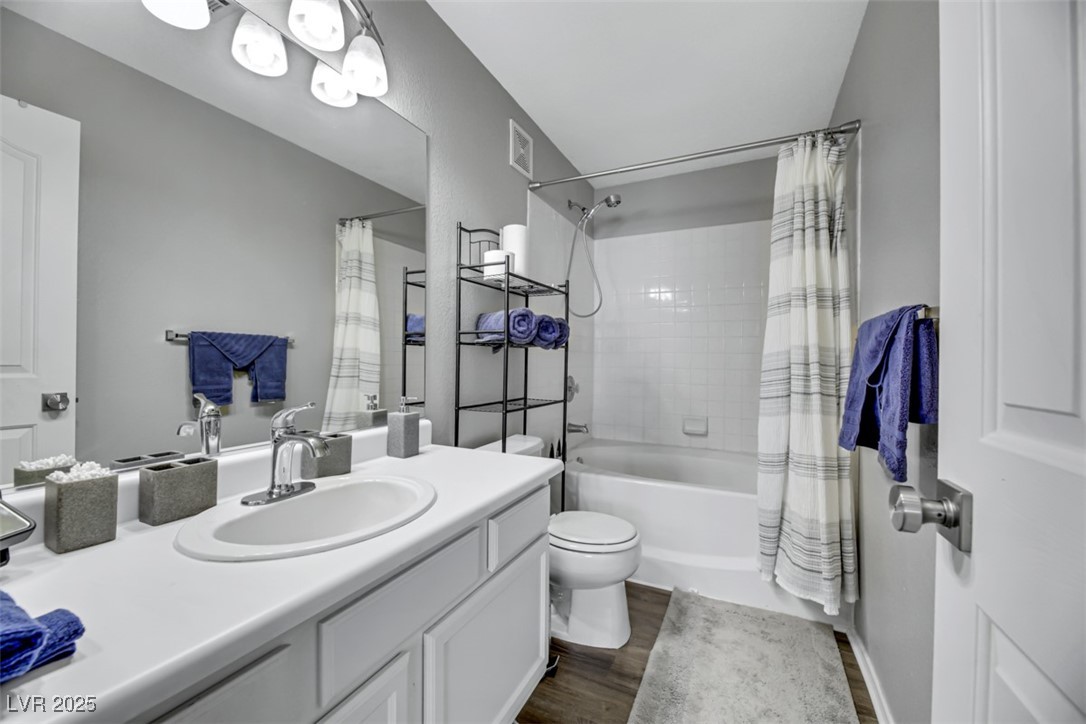 2907 Rio Sonora Court Henderson, NV 89074 - Photo 23 of 35 Bathroom with vanity, shower / tub combo with curtain, and dark wood finished floors