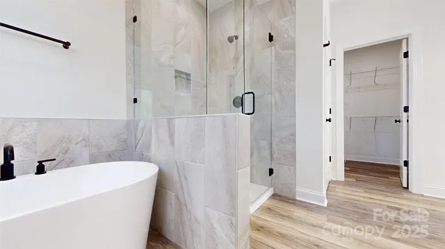 a bathroom with a bathtub a toilet and a shower