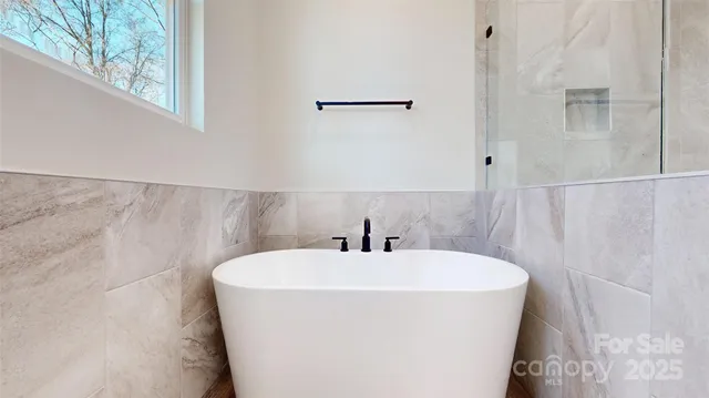 a white bath tub sitting in a bathroom