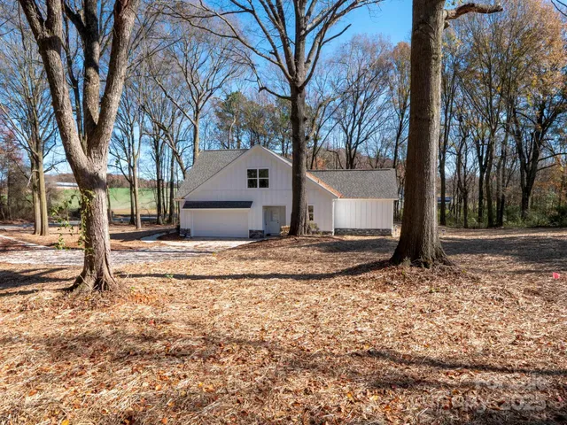 a view of a house with a yard covered in snow
