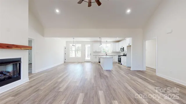 a view of kitchen with wooden floor and a fireplace