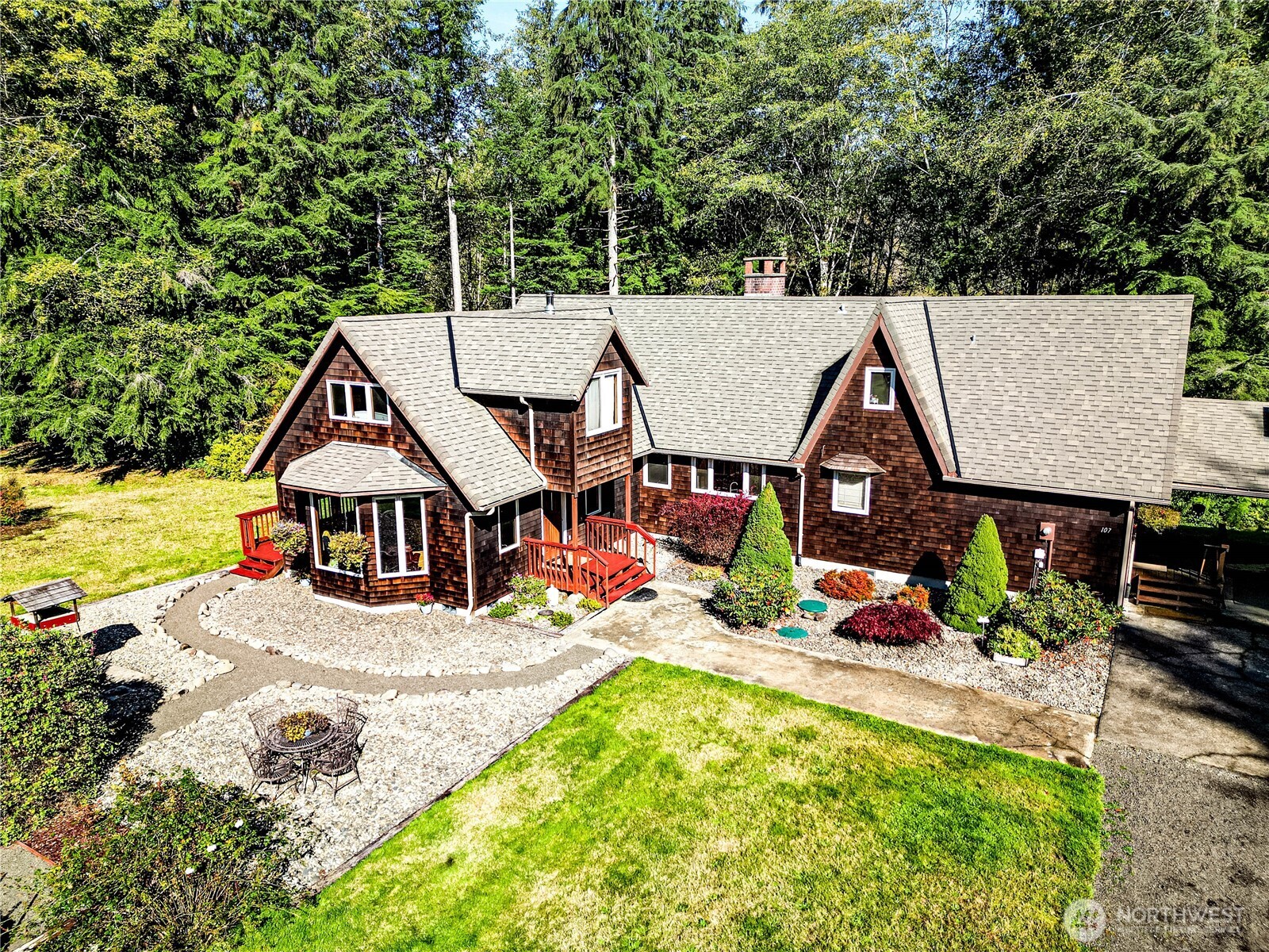 an aerial view of a house with swimming pool and furniture