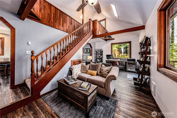a living room with furniture or stairs and a wooden floor