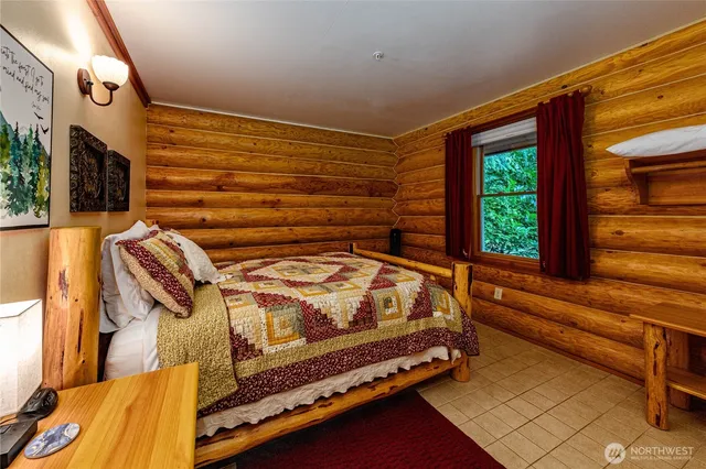 a bed sitting in a bedroom next to a window