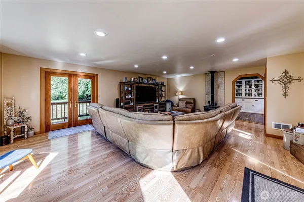 a living room with couches a dining table chairs and couches with wooden floor