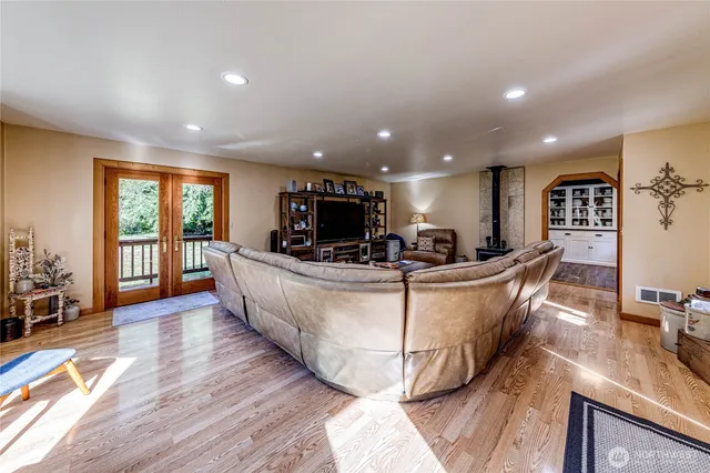 a living room with couches a dining table chairs and couches with wooden floor