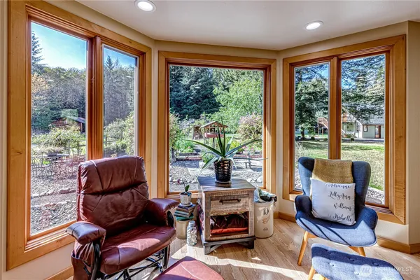 a living room with furniture and a floor to ceiling window