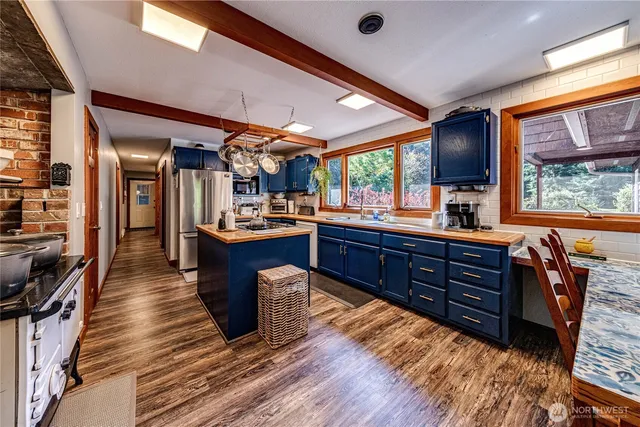 a room with lots of wooden furniture and appliances