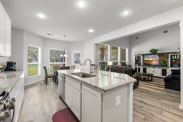 a large kitchen with lots of counter space and windows