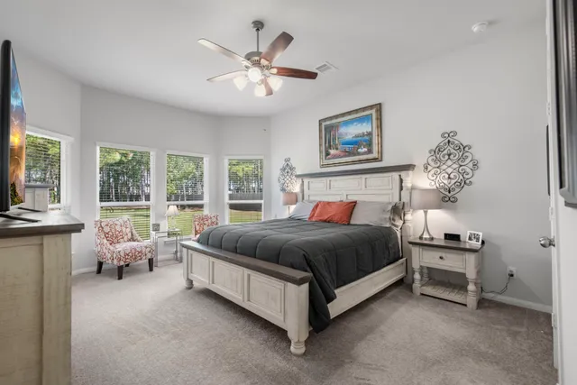a spacious bedroom with a bed and a chandelier
