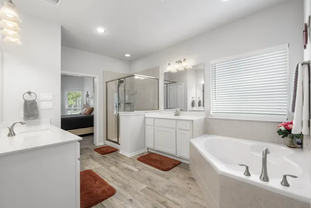 a bathroom with a tub sink and mirror