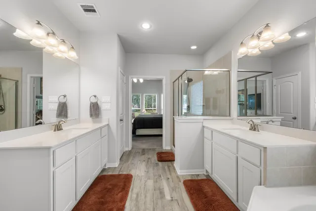 a large bathroom with a double vanity sink and a mirror