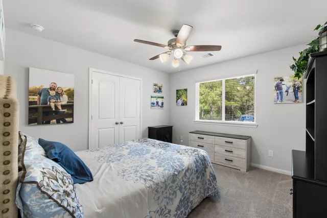 a bedroom with a large bed and a window