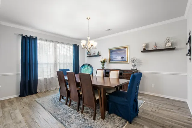 a view of a dining room with furniture and window