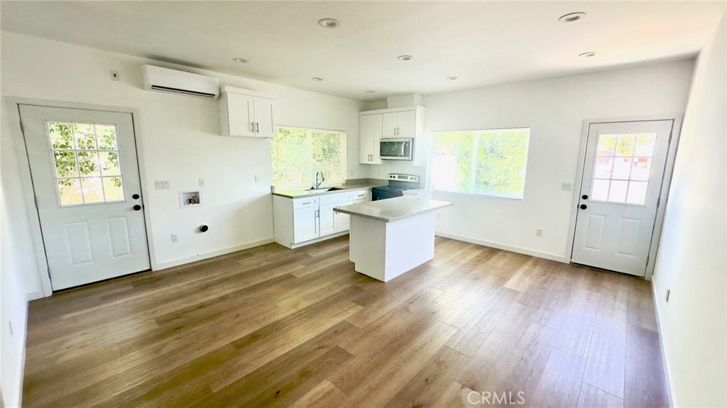 1565 1/2 Atchison Street Pasadena, CA 91104 - Photo 2 of 10 a room with wooden floors and white walls