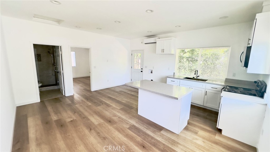 1565 1/2 Atchison Street Pasadena, CA 91104 - Photo 3 of 10 a kitchen with white cabinets and white appliances