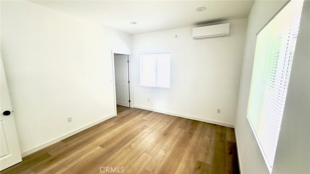 1565 1/2 Atchison Street Pasadena, CA 91104 - Photo 6 of 10 a view of an empty room with wooden floor and a window