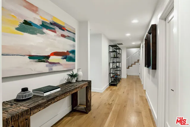 a kitchen with stainless steel appliances granite countertop a lot of cabinets and wooden floor