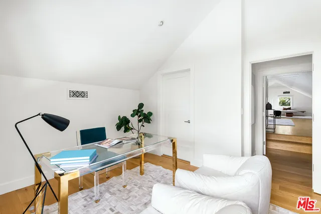 a living room with furniture and view of kitchen
