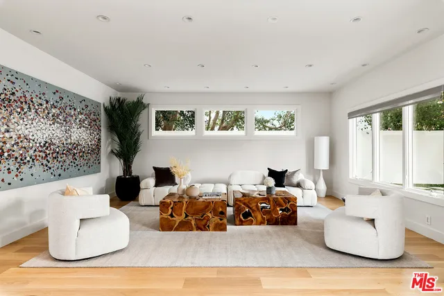 a bedroom with furniture and a large window